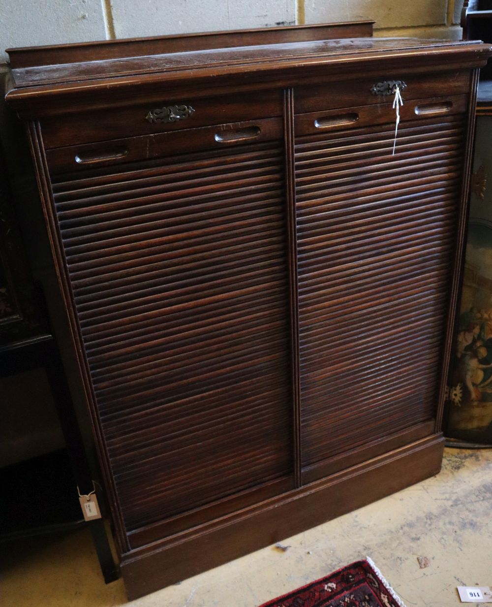 A walnut double tambour filing cabinet, circa 1935, fitted sliding trays, width 90cm, depth 42cm, height 116cm